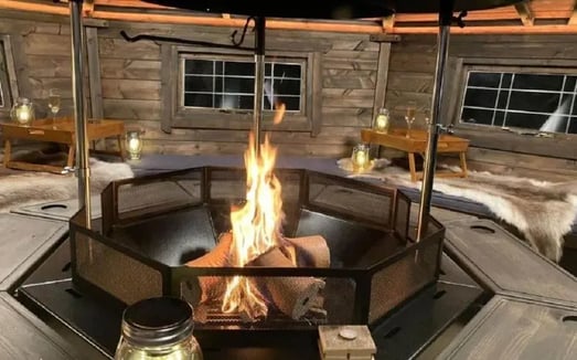 BBQ log cabin interior with a lit fire