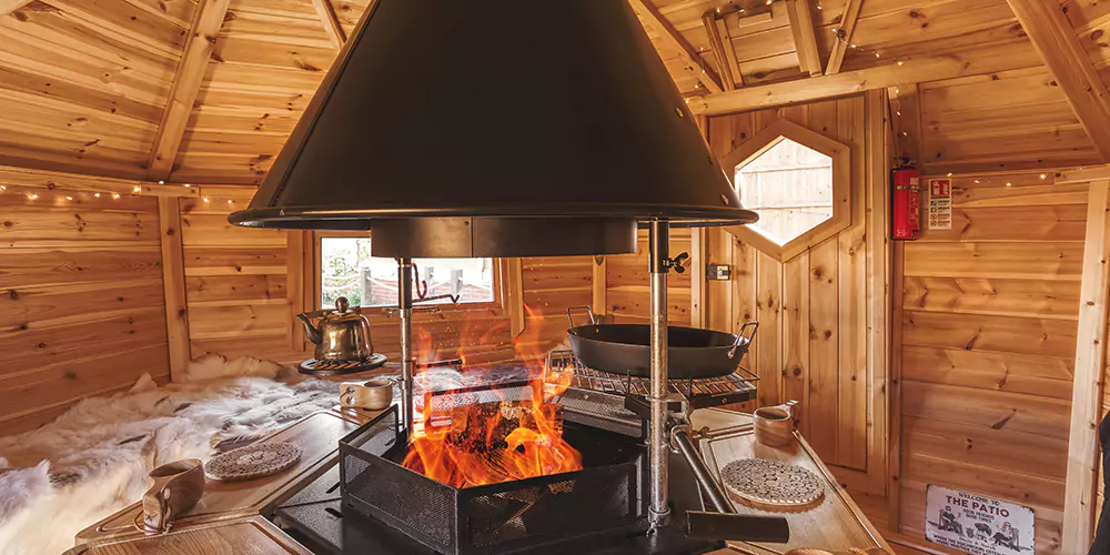 Interior of a Scandinavian BBQ log cabin with a roaring fire